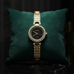 Elegant gold Donaler quartz watch with crystal accents on green cushion, luxury gift at The Manay