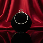 Elegant diamond hoop pendant on black display with red silk backdrop, The Manay jewelry