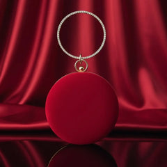 Luxury round red clutch bag with gold ring handle on red satin, The Manay fashion
