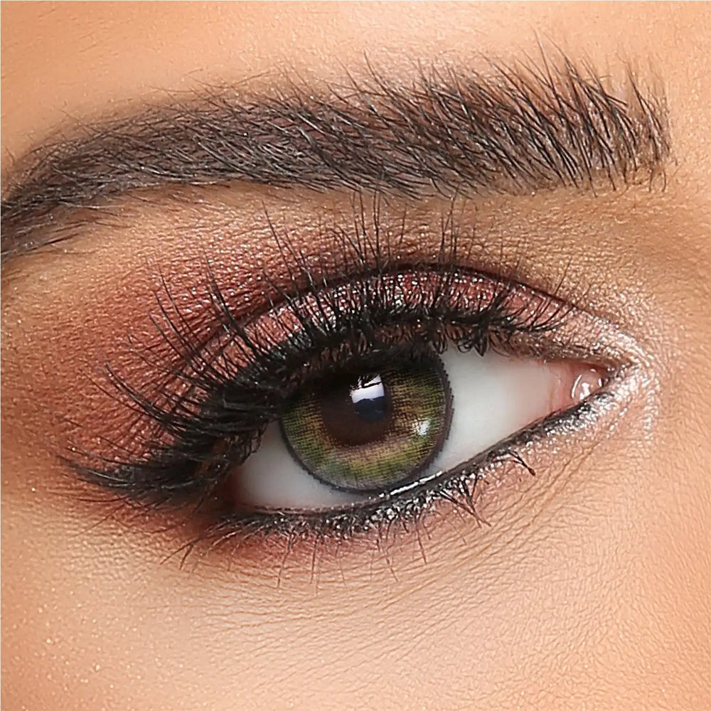 Green contact lens on realistic eye with bold lashes and brown eyeshadow, Seoeyewear