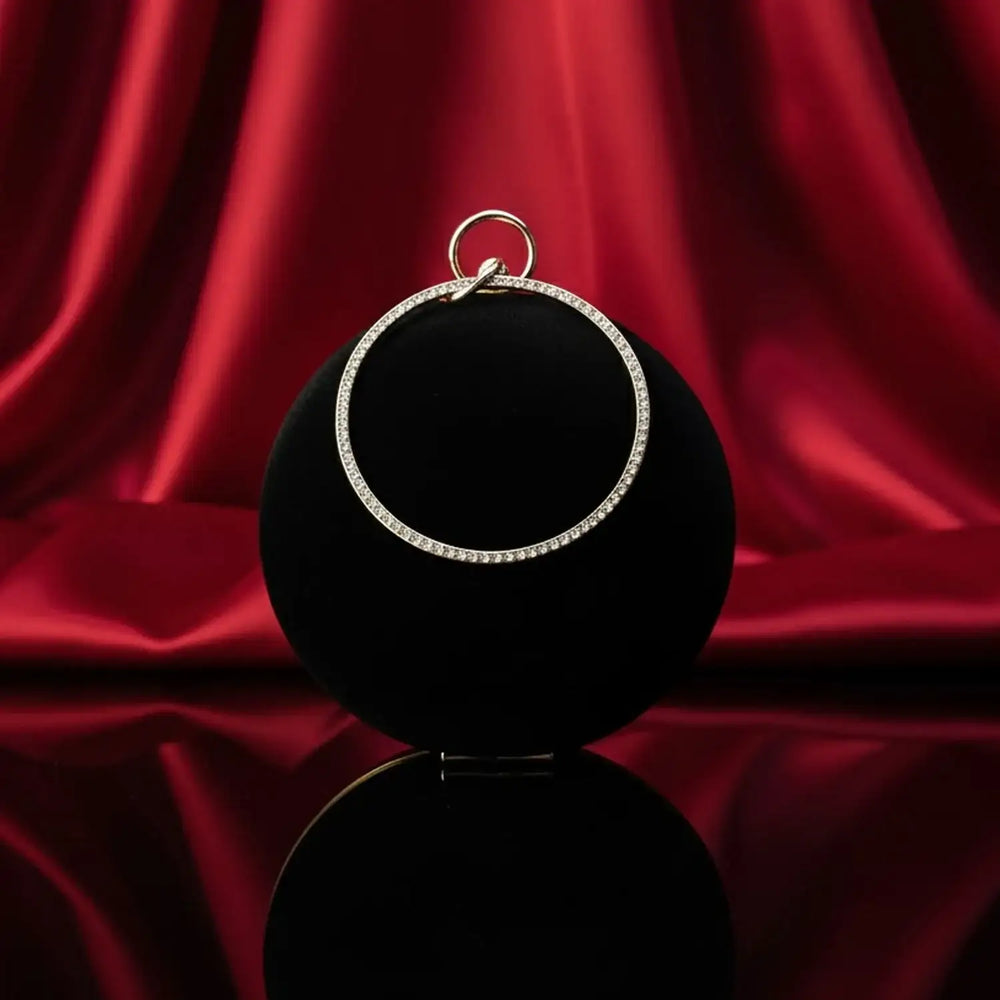 Elegant diamond hoop pendant on black display with red silk backdrop, The Manay jewelry