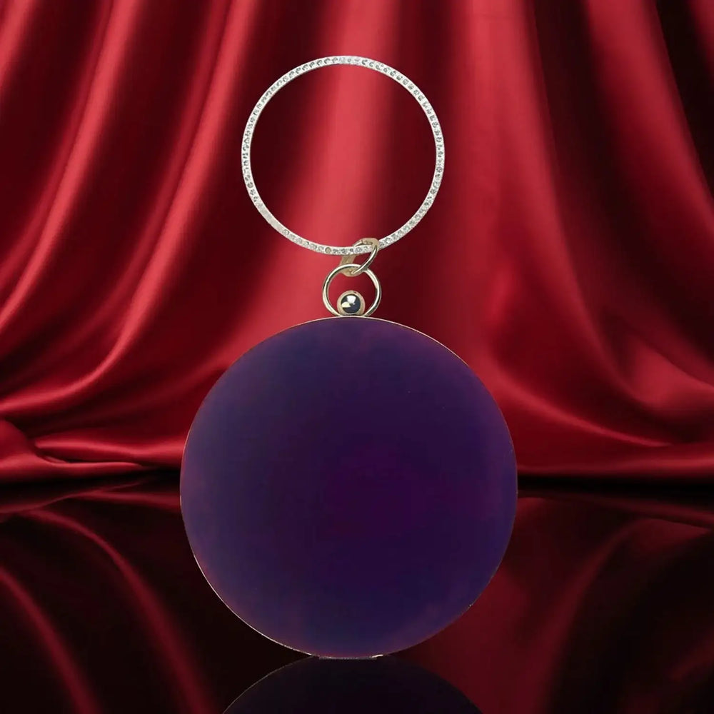 The Manay luxury purple round keychain with crystal ring on red satin background